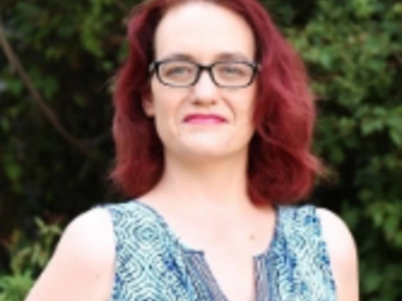 woman with glasses smiling