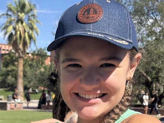girl with hat smiling