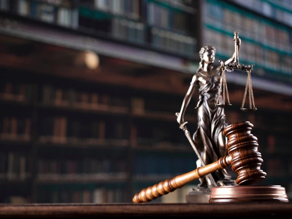 This is an image of a gavel in front of the scales of justice