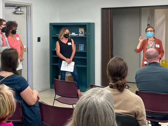 A group of four standing educators speak to an audience about Wildcat Writers