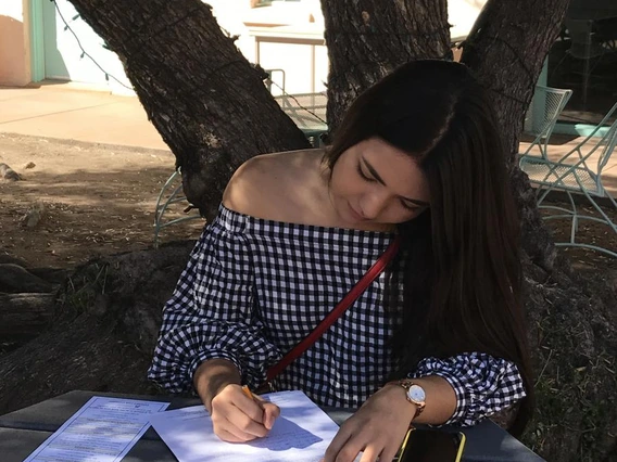 a student composing her writing contest submission.