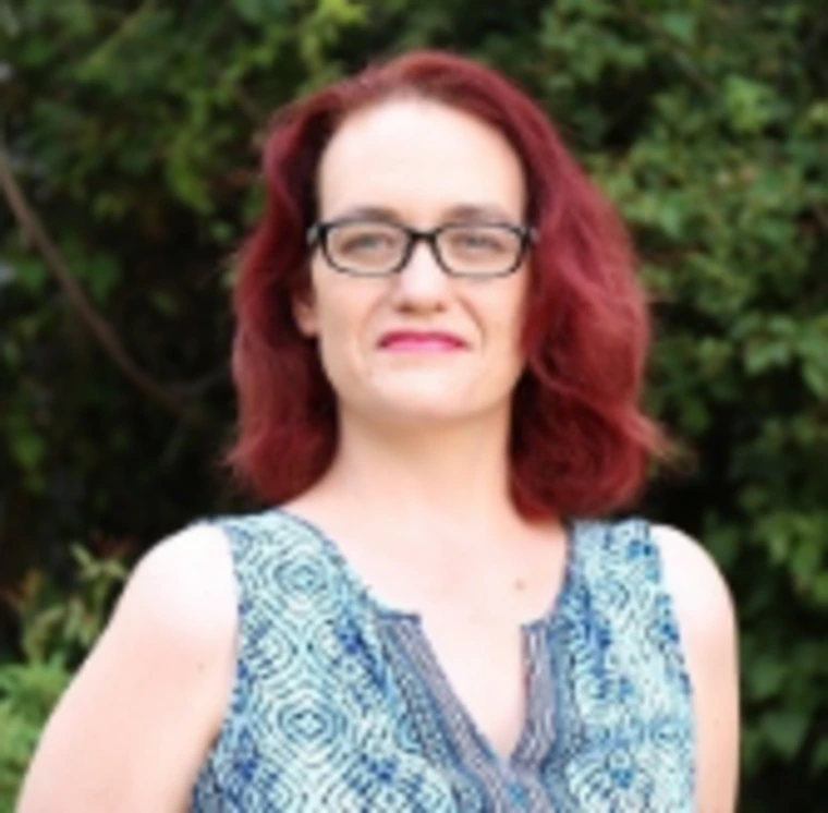 woman with glasses smiling