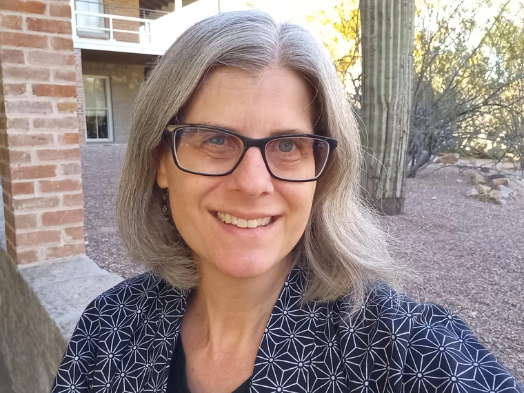Woman with glasses smiling