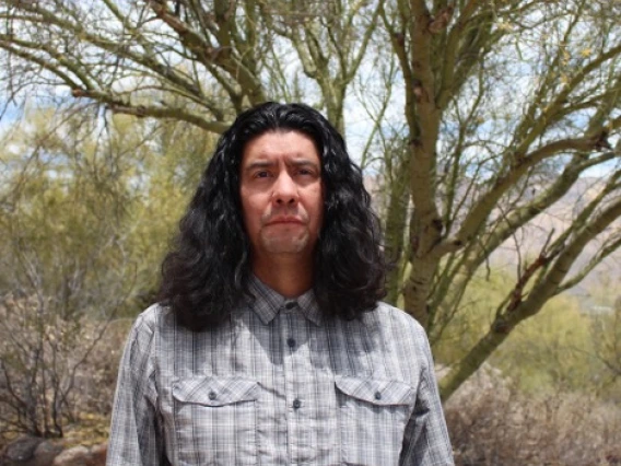 Man standing in front of tree