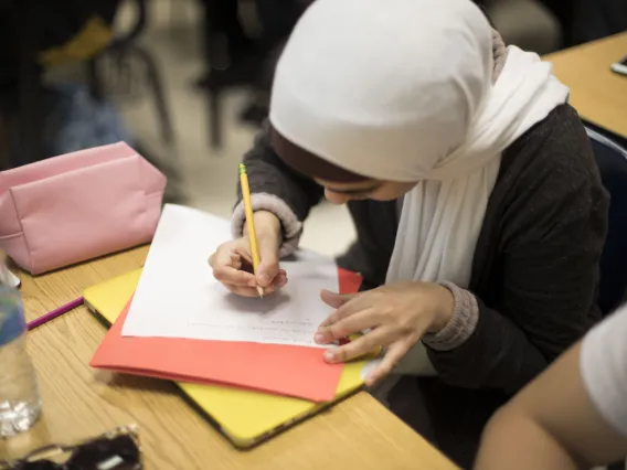 Female student writing in class