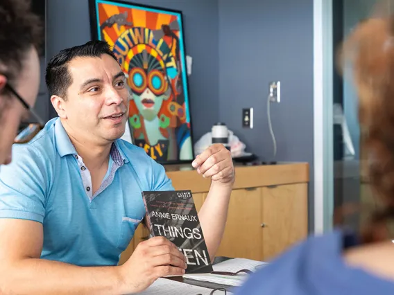 Professor introducing a book to his students