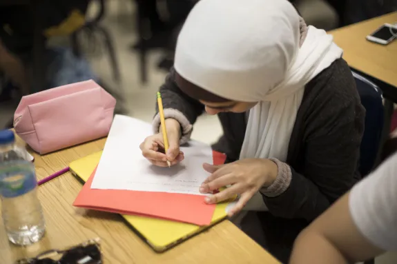 Female student writing in class