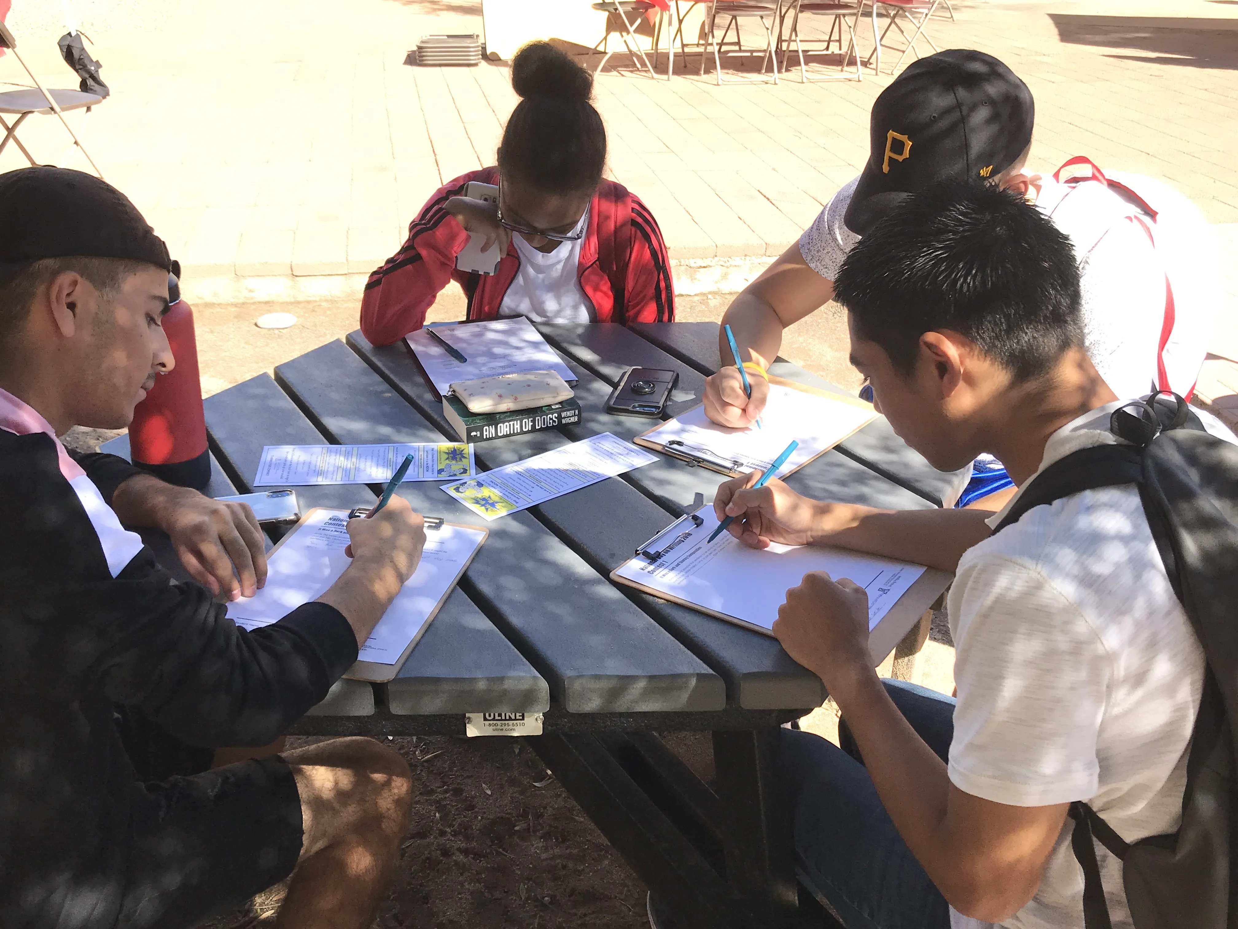 Four students writing at the National Day on Writing 2018 event