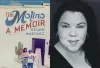 woman smiling next to book cover