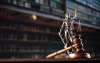 This is an image of a gavel in front of the scales of justice